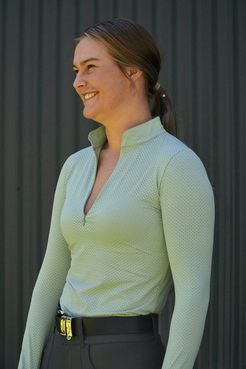 Model wearing lightweight perforated training shirt in Seafoam by Wilma Sport