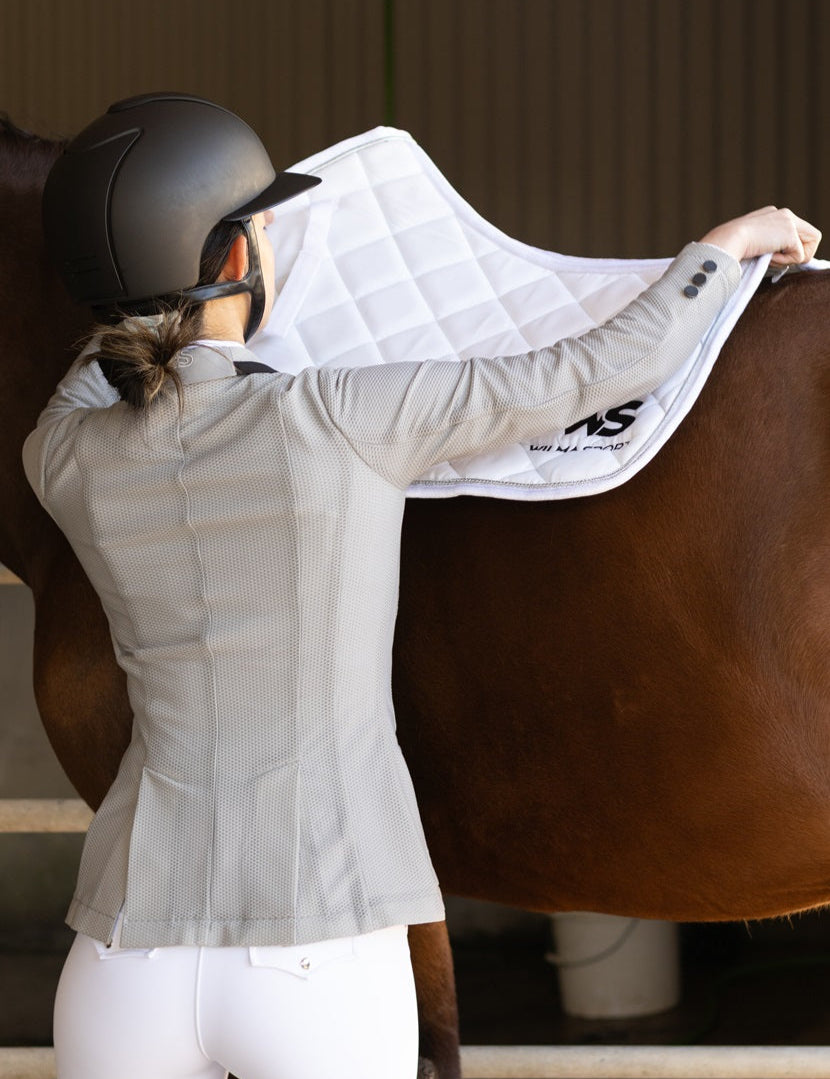 Back view of Wilma Sport Aero Competition Jacket in Platinum, showing breathable mesh panels, beside horse.